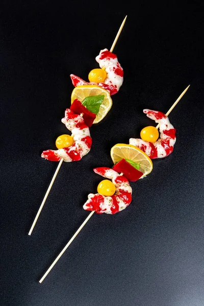 Delicious skewers of shrimp on a wooden sticks