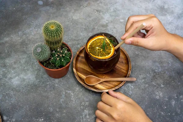 Cactus next to a Glas of Burnt Orange Cold Brew Coffee with a Pe