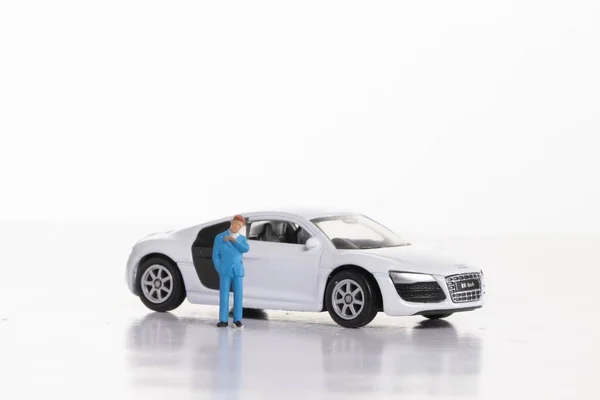 Man with sports car on white background