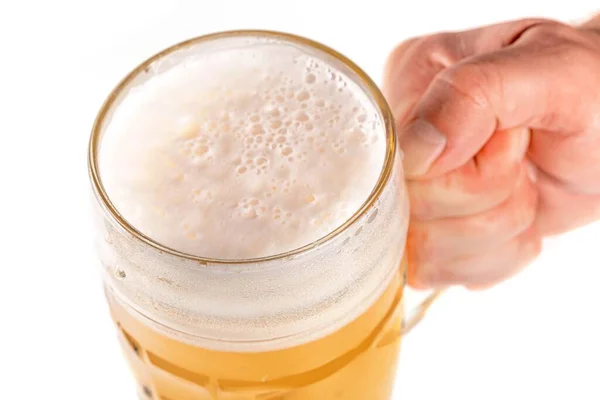 Hand holding glass of beer on a white background, close up