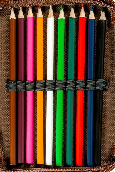 Sharpened colored pencils in a pencil case, top view
