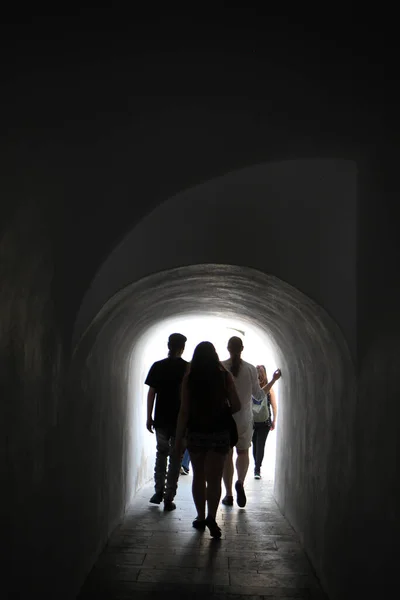People walking through a tunnel