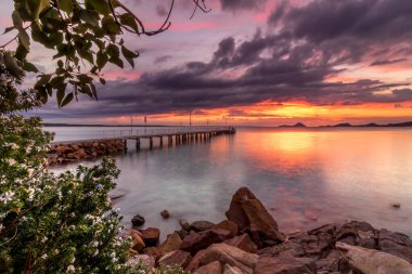 Sunrise overlooking jetty in Salamander Bay, Port Stephens, NSW, Australia.