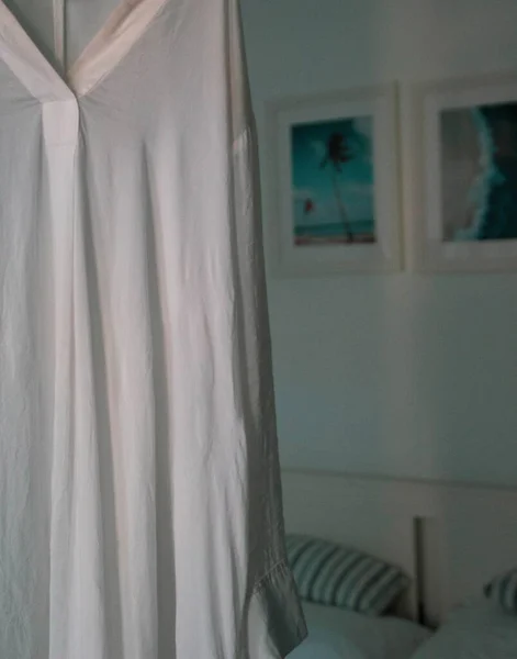 LIFESTYLE. WHITE DRESS IN A ROOM WITH COLD SUMMER COLORS. SUMMER APARTMENT ON THE SEASIDE.
