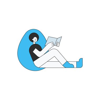 Çocuk oturuyor ve bir kitap okuyor..