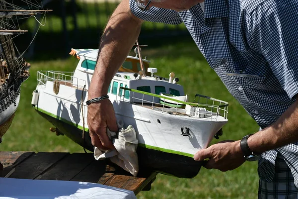 scale model of remote-controlled boats on a pond
