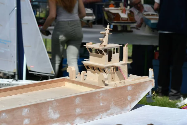 scale model of remote-controlled boats on a pond