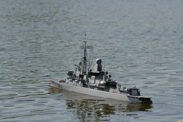 scale model of remote-controlled boats on a pond