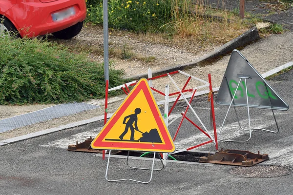 road sign with a warning symbol