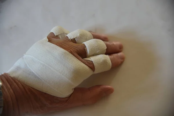 bandages on the fingers and the palm of the hand