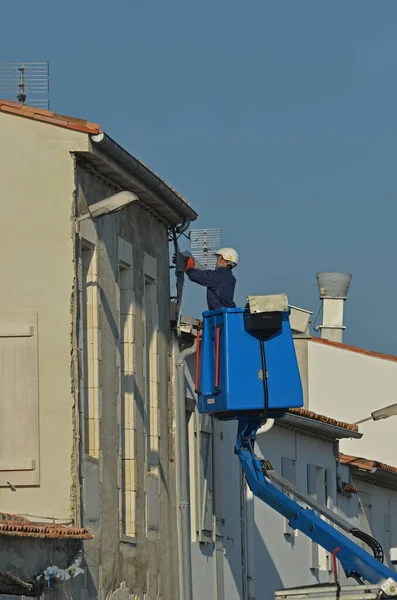 electrician worker repairing an outdoor electrical installation in a nacelle