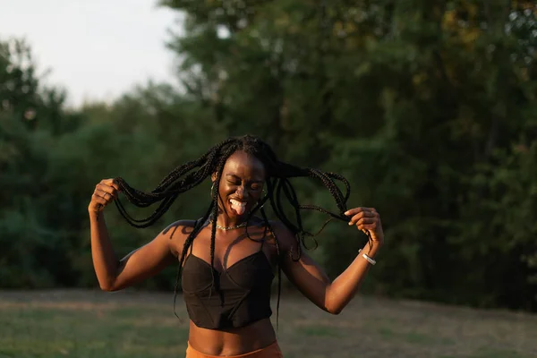 Portrait Young Black Female Playfuly Moving Her Braids While Sticking — Fotografia de Stock