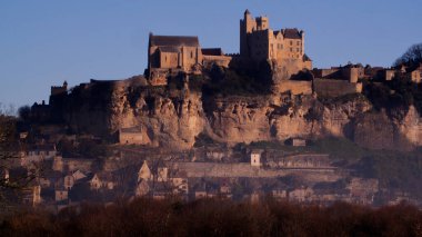 Large shot of the castle of Beynac at sunrise, the castle is built on a cliff