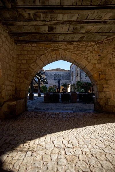 old stone arch in the city of Monpazier in France
