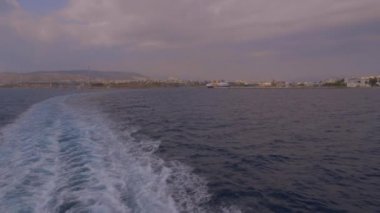 Gemi Piraeus limanından ayrıldı, Anthens 'ın denizdeki açılı görüntüsü.