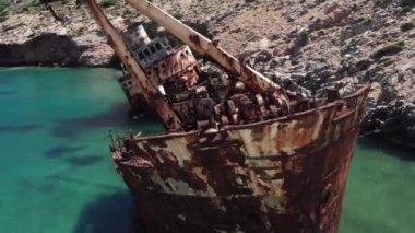 Spin aerial drone video of famous shipwreck of Olympia abandoned in Liverio bay near Kalotaritissa village, Cyclades islands, Greece