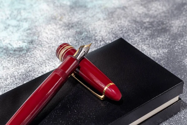 Fountain pen on a marble and gray background. Selective focus. copy space.