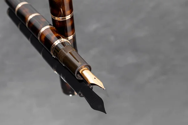 Fountain pen on a marble and gray background. Selective focus. copy space.