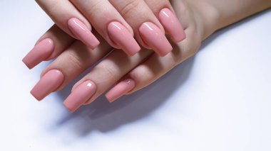 Acrylic nail extension, manicure, nail correction, hands in the foreground. copy space