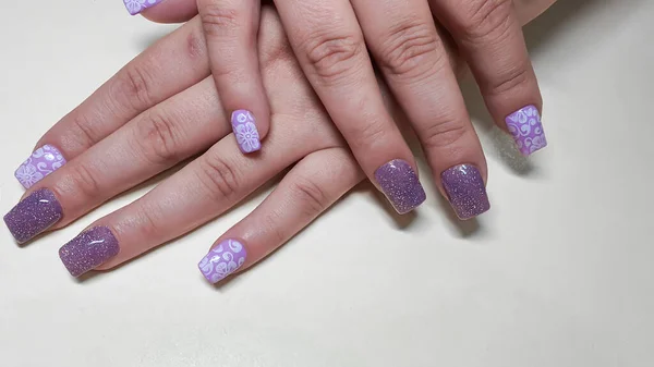 Acrylic nail extension, manicure, nail correction, hands in the foreground. copy space