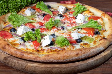 Pizza with bacon and cheese, herbs and cherry tomatoes. With mozzarella, shrimp and octopus, mussels and other products on a wooden background. fast food