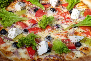 Pizza with bacon and cheese, herbs and cherry tomatoes. With mozzarella, shrimp and octopus, mussels and other products on a wooden background. fast food