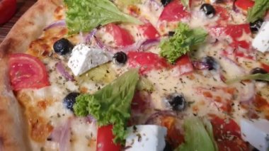 Pizza with bacon and cheese, herbs and cherry tomatoes. With mozzarella, shrimp and octopus, mussels and other products on a wooden background. fast food