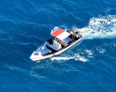 Motorboat in turquese waters of Sint Maarten harbor