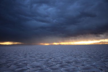 Gün batımında tuzlu ve düz çölde fırtına