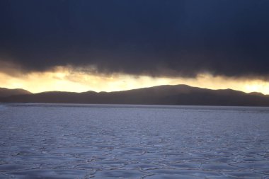 Gün batımında tuzlu ve düz çölde fırtına