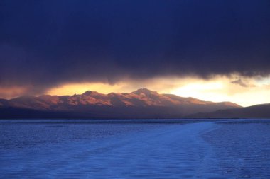 Gün batımında tuzlu ve düz çölde fırtına