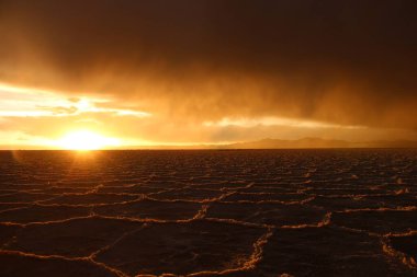 Gün batımında tuzlu ve düz çölde fırtına