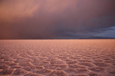 Gün batımında tuzlu ve düz çölde fırtına