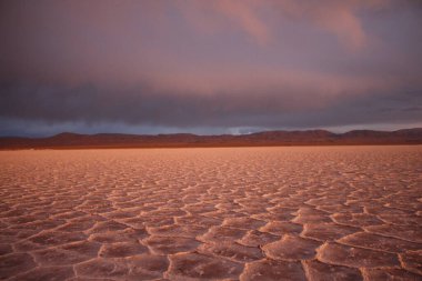 Gün batımında tuzlu ve düz çölde fırtına