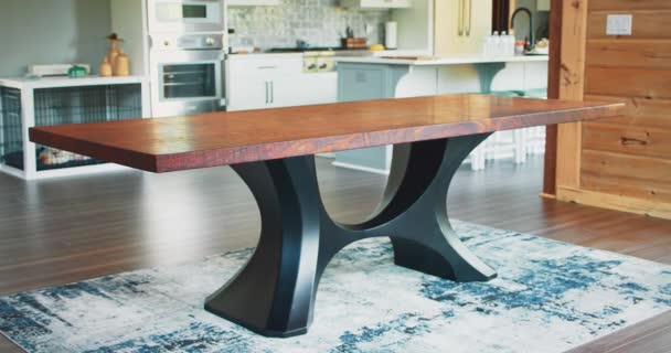 Modern wood dinning table with black metal legs inside a cabin house. — Wideo stockowe