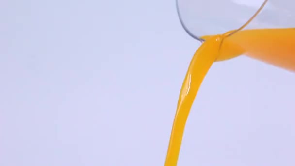 Orangensaft Ein Glas Auf Weißem Hintergrund Gießen — Stockvideo