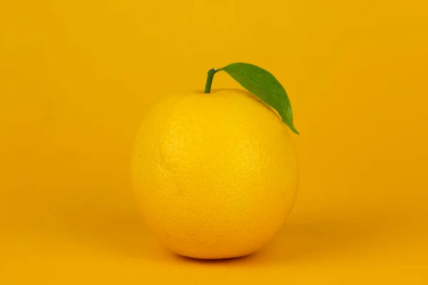 A lemon isolated on yellow background. yellow lemon for healthy fruit concept design