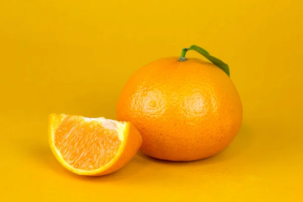 Fresh Orange fruit with leaf isolated. Orang whole, slice, leaf on yellow background. Orange slice with isolated pattern