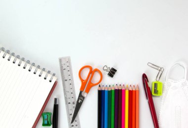 Set of Education elements, colorful pencils, face mask, paper clips, scissors, ruler  isolated on white background. Back to school concept