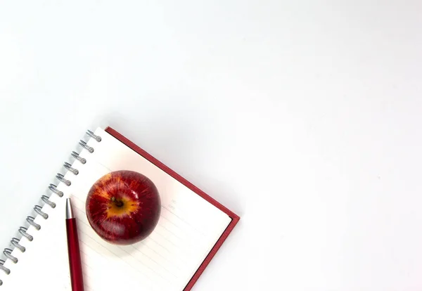 Back to school concept with education materials, note book, apple, pen isolated on white background. Top view of studying elements for kids learning concepts templates