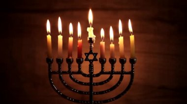 Karanlık arka planda Hanuka için mum yakan Menorah.
