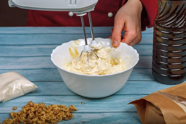 Beat egg whites and granulated sugar with an electric mixer.
