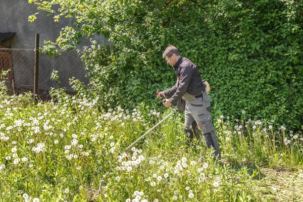Man Mows Grass Garden Gasoline Trimmer Wore Eye Glasses Protect — Stok Foto