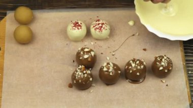 The process of making sweets at home. Glazing white chocolate candies.