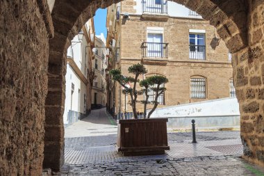 CADIZ, SPAIN - MAY 22, 2017: It is an arch in the old residential Populo District.