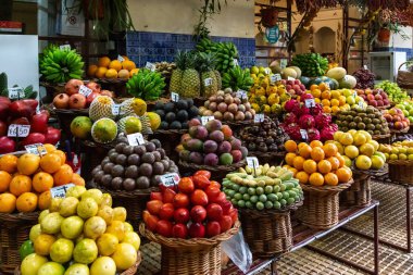 FUNCHAL, PORUGAL - AUGUST 24, 2021: This is a stall at the Farmers Market teeming with tropical fruits.