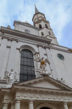 VIENNA, AUSTRIA - MAY 15, 2019: This is a view of the facade and the belfry of the old Church of St. Michael at Michaelerplatz.