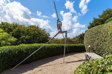 ETRETAT, FRANCE - SEPTEMBER 1, 2019: This is a contemporaty sculpture Conquest of the Summit in the Garden of of Amun in the Etretat Gardens.