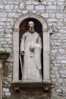 SIBENIK, CROATIA - SEPTEMBER 9, 2016: This is an ancient sculpture in a niche of the medieval building of the city museum.