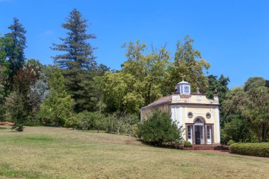 SAO GONCALO, PORTUGAL - AUGUST 20, 2021: This is a chapel in the botanical gardens of the Palheiro estate in a clearing among rare old trees.